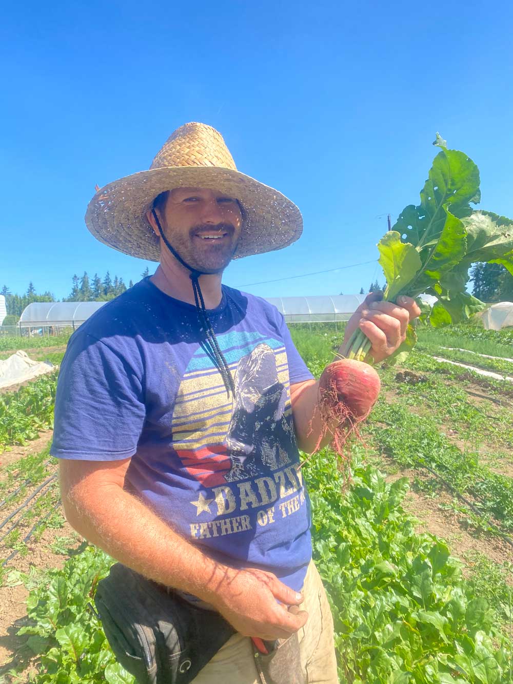 Farm manager Gary smiles with a giant beet