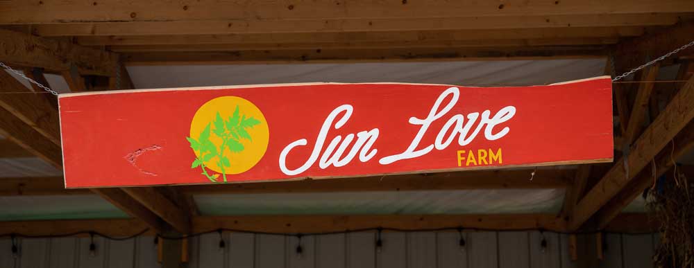 Sun Love Farm sign in our CSA pickup area