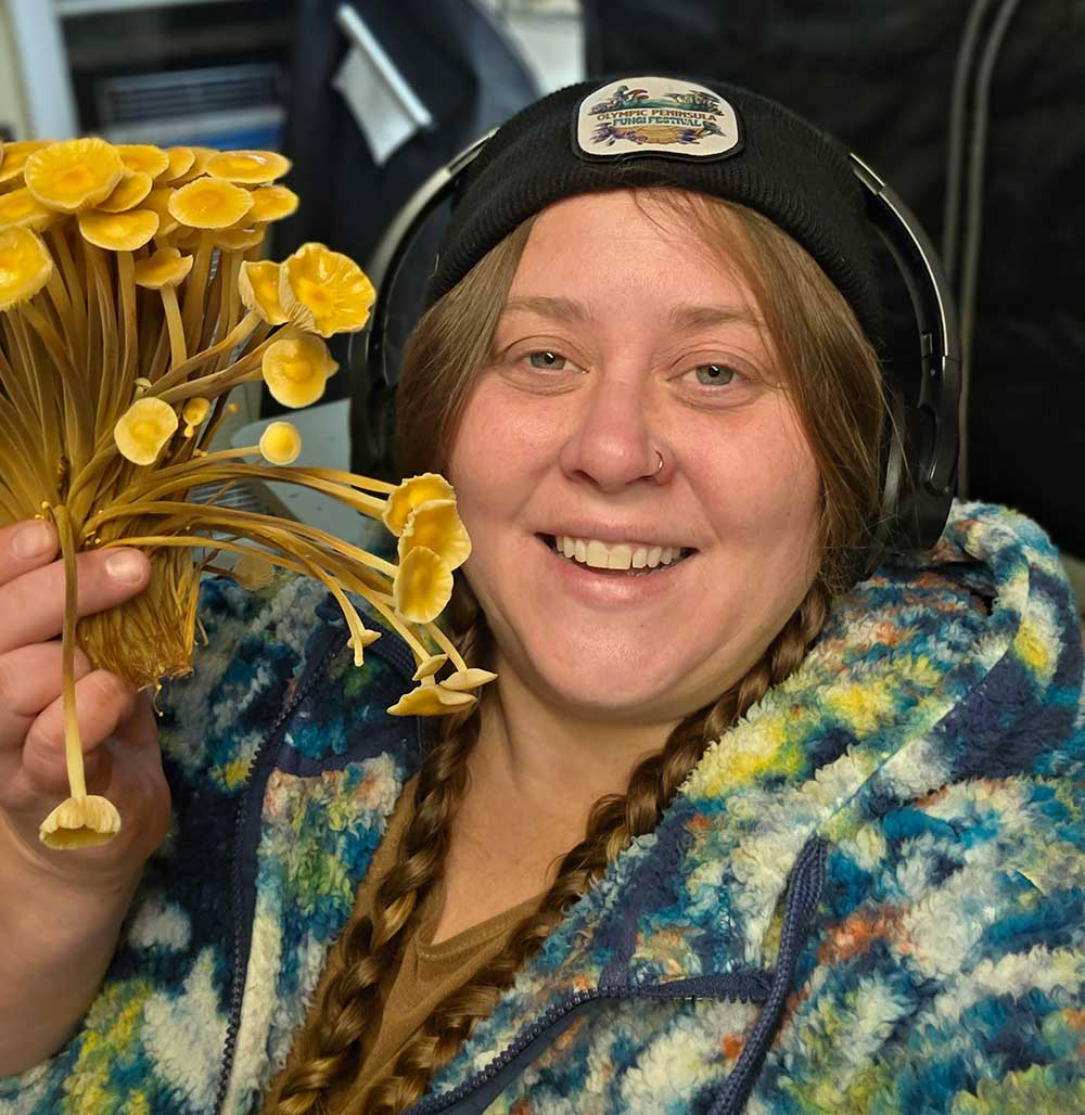 Anna from Brown Bottle Farm with a bouquet of mushrooms from her mushroom CSA add-on